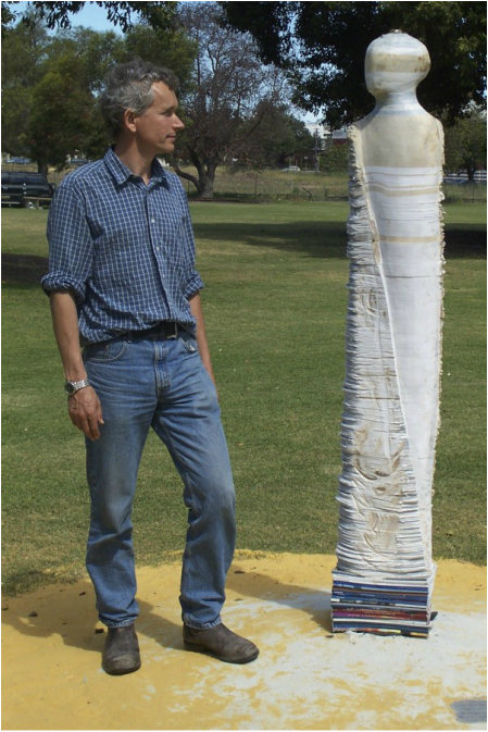 Picture of Artist Graham Hay with “Bureaucraft I” made 2002, an outside sculpture of Government documents, 200 x 40 x 20cm, Photo: Frances Dennis.