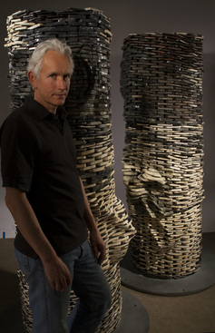 Picture of artists Graham Hay with The Kiss sculpture made from thousands of ceramic smart phones.  Photographer is Kevin Gordon.