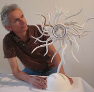 Picture of Artist Graham Hay in Robertson Park Artists Studio with paper clay sculpture he is  decorating. Photo:  Graham Hay
